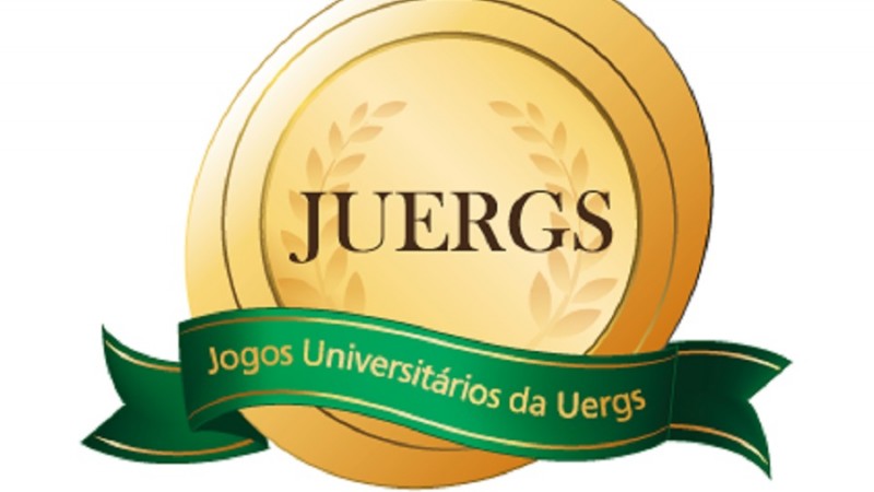 Logotipo do Juergs: medalha dourada, com um tom claro no centro e duas pencas de folhas de louro em tom mais escuro, nas laterais. Junto à base da medalha, uma faixa verde escrito em dourado 'Jogos Universitárias da Uergs'.